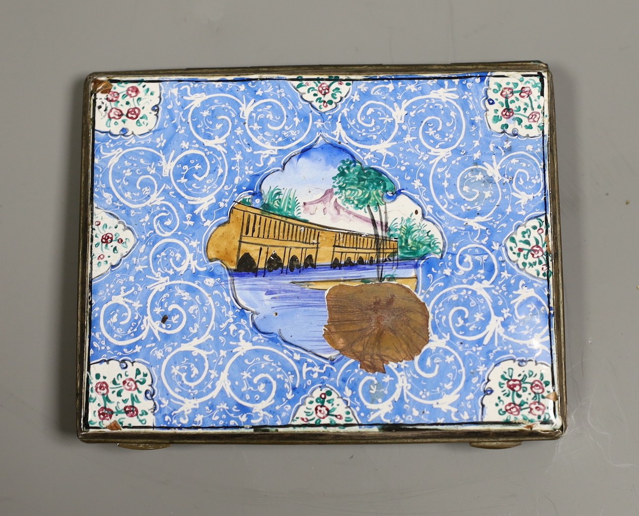 A Persian enamelled cigarette case, 10 cms wide